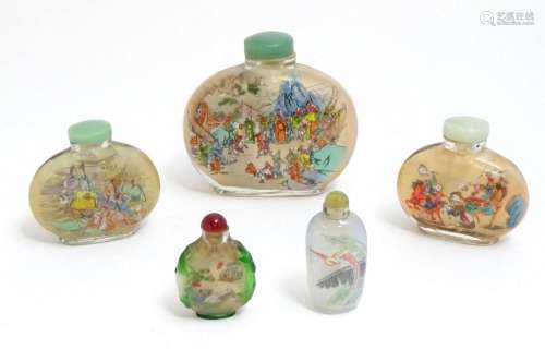 Five Oriental glass snuff bottles with reverse glass decorat...