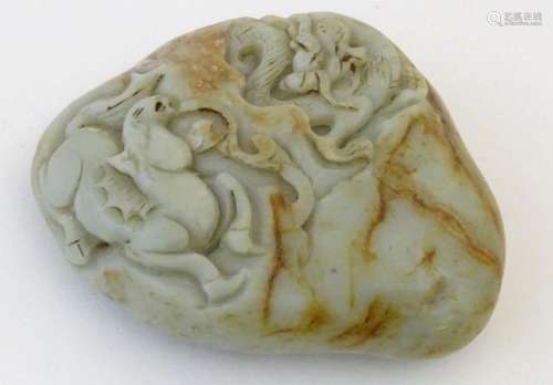 A Chinese jade scroll weight with carved decoration depictin...