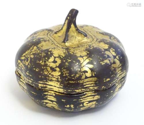 An Oriental lacquered pot and cover modelled as a gourd with...
