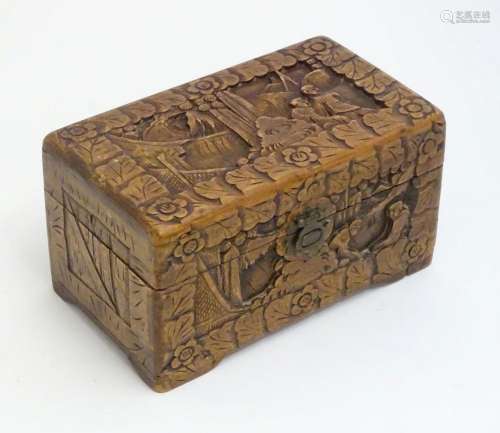 A 20thC Chinese carved camphor wood hinged box depicting lan...