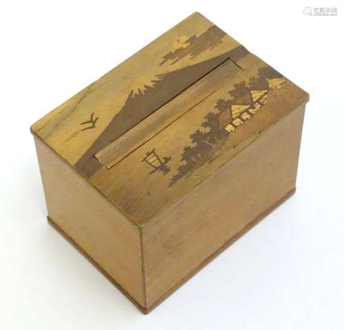 An Oriental cigarette dispensing box with marquetry / parque...