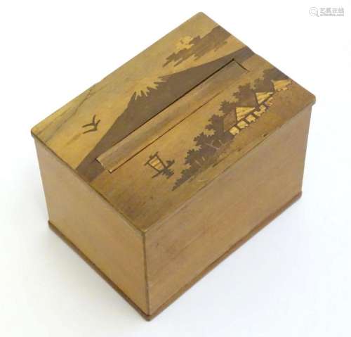 An Oriental cigarette dispensing box with marquetry / parque...