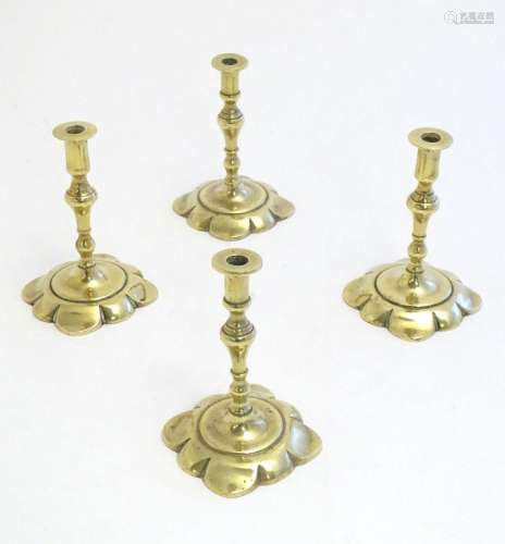 Four 19thC cast brass taper sticks with shaped bases. Approx...