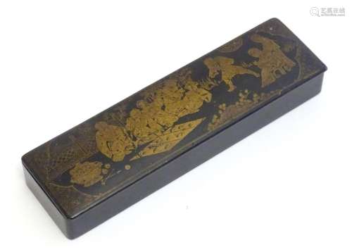 An early 20thC lacquered papier mache pen box decorated with...