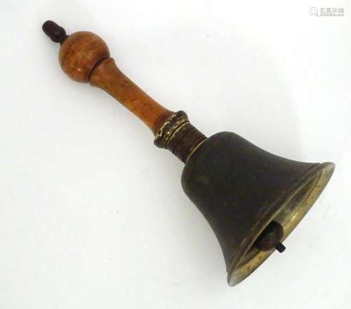 A 20thC hand bell with a turned wooden handle and acorn fini...