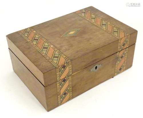 An early 20thC walnut work box with inlaid stained geometric...