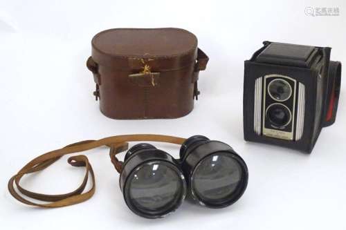 An early 20thC pair of field binoculars with sun shades, the...
