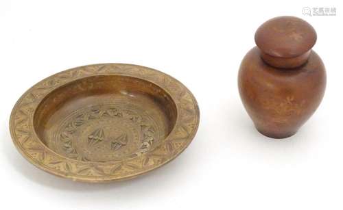 Two 20thC treen items comprising a jar and cover with foliat...