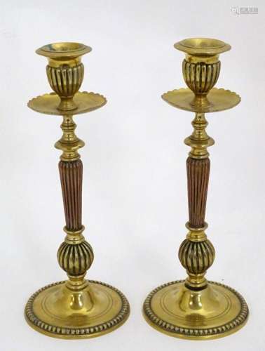 A pair of 19thC brass candlesticks with copper reeded column...