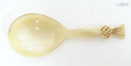 A 20thC horn caddy spoon with carved pineapple finial. Appro...