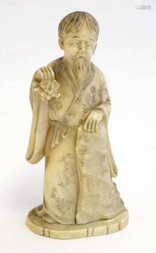 A 19thC Oriental carved ivory figure depicting a gentleman i...