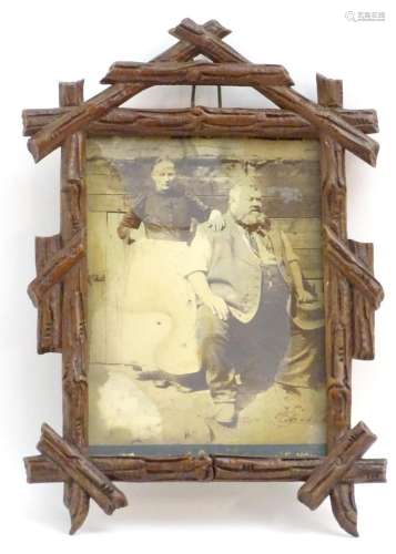 A 20thC carved wooden photograph frame in the black forest s...