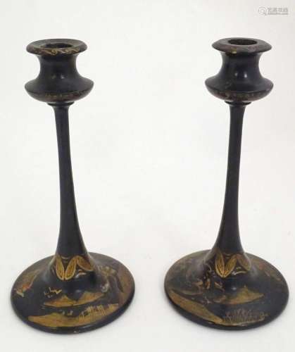 A pair of late 19thC lacquered candlesticks with chinoiserie...