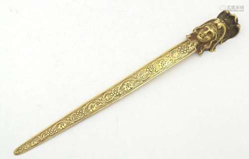 An early 20thC brass letter opener with classical head finia...