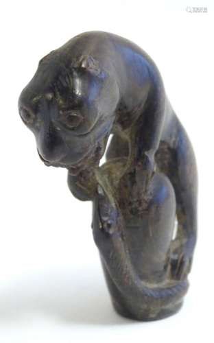 An Indian carved cane handle modelled as a stylised big cat ...