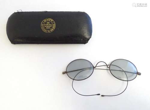 A cased pair of early 20thC spectacles / glasses with a stee...