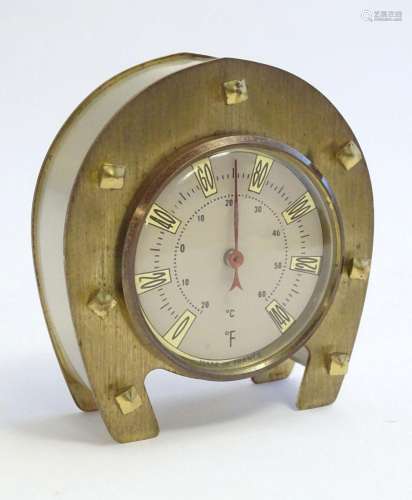 A 20thC French thermometer mounted within a horseshoe frame....
