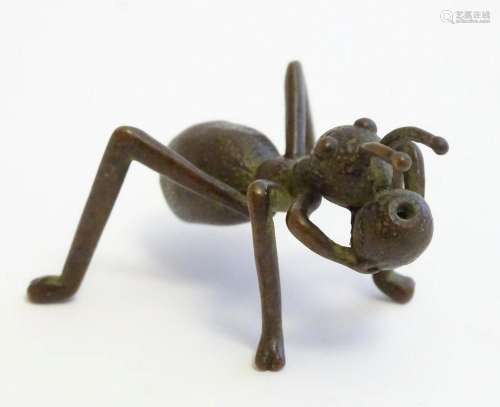 A 20thC cast model of an ant / insect with a berry. Approx. ...