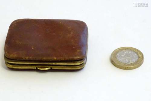 A Victorian small leather coin purse with gilt metal mounts....