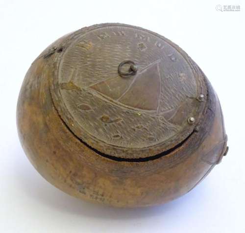 A 19thC carved coconut with a hinged lid decorated with a na...