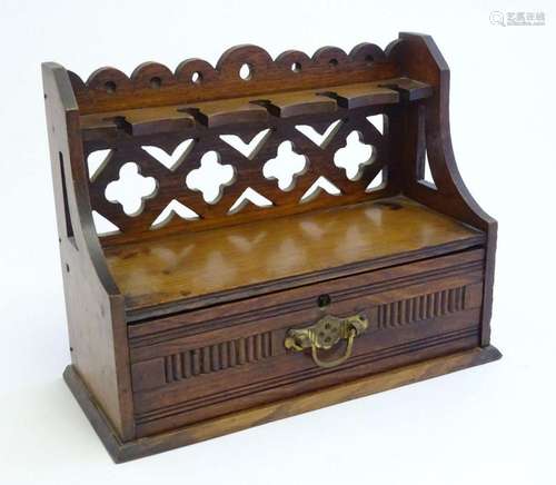 A late 19th / early 20thC oak pipe rack with the provision f...