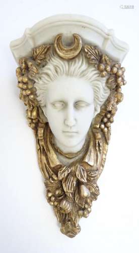A 20thC cast wall bracket modelled as the head of the goddes...