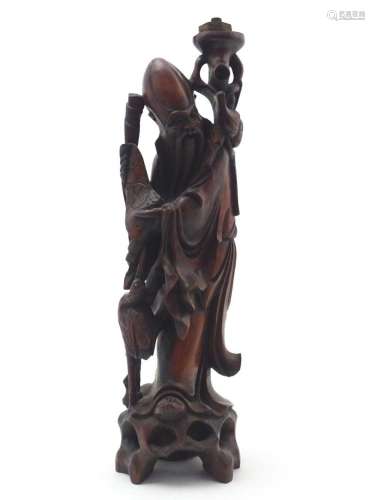 A 20thC Chinese carved wooden figure modelled as an elder wi...