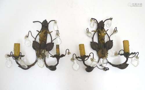 A pair of early 20thC Continental wall lights, decorated wit...