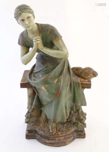 A 20thC French terracotta sculpture of a seated woman on a b...