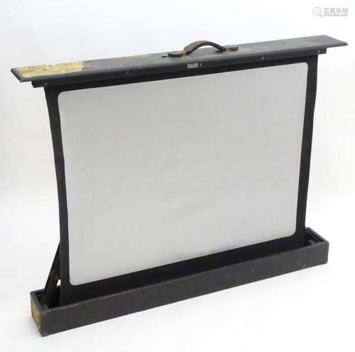 A 20thC projector / cine screen, The Celfix. In a fitted cas...