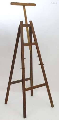 A 20thC large wooden artist's easel, the uprights with ...