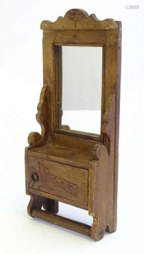 A 20thC naive wooden wall unit with mirror and small cupboar...
