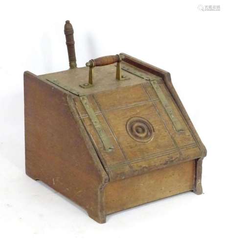 A Victorian oak coal scuttle in the manner of Christopher Dr...