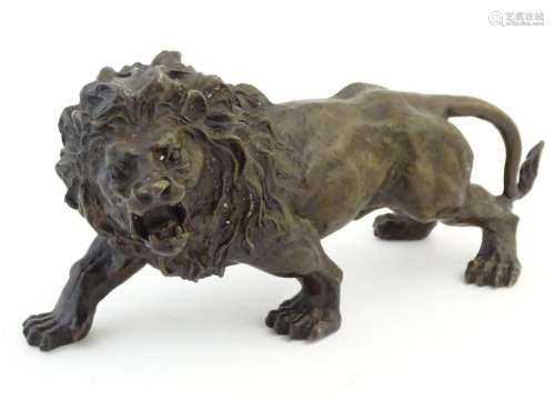 A 19thC cast bronze model of a prowling lion, signed 'R...