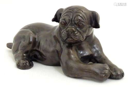 A 20thC cast model of recumbent dog / pug. Approx. 4 3/4&quo...