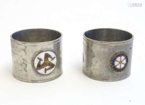 Two pewter napkin rings with hammered decoration, one with a...