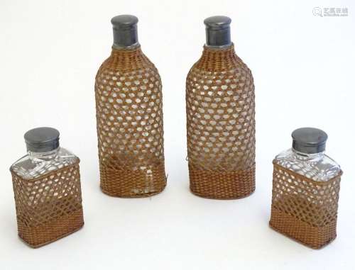 Four 20thC glass bottles / flasks with wicker covers. Larges...