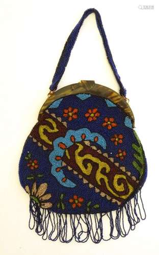 An early 20thC bead work bag / purse with stylised floral an...