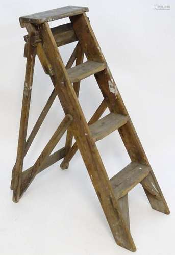 An early to mid 20thC wooden shop step ladder, latticed and ...