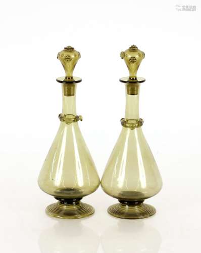 A pair of continental green glass decanters, having raised P...