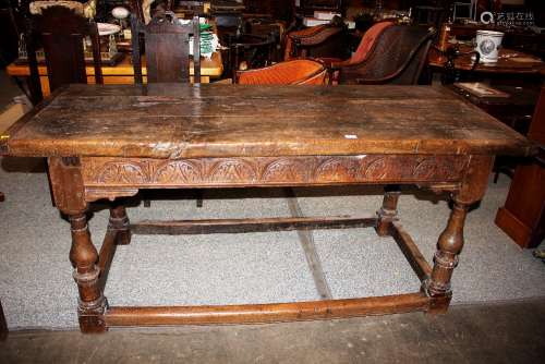 A large 18th Century rustic oak refectory table, the thick p...