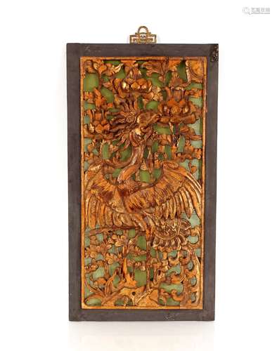 A Chinese carved and lacquered panel, depicting an exotic bi...