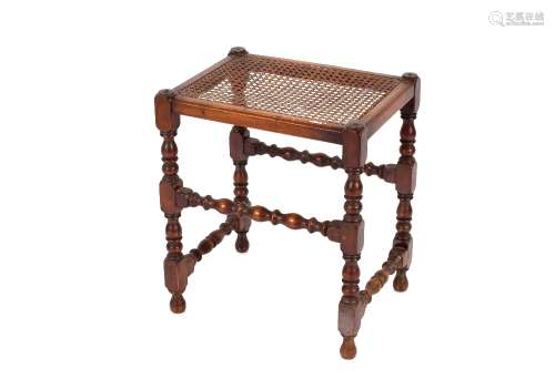 A Victorian low stool, raised on turned baluster supports an...