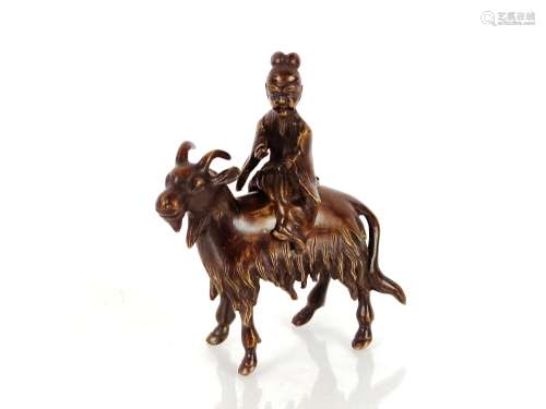 A Chinese bronze censer, in the form of a man riding a goat,...