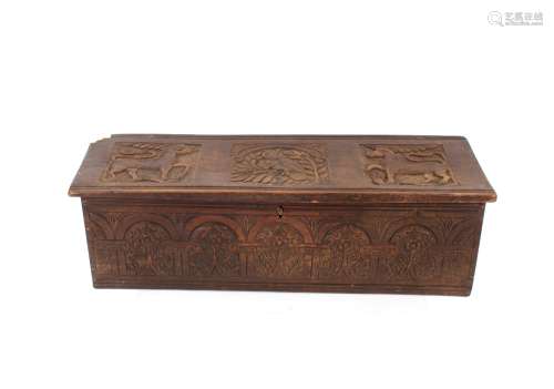 An antique carved oak coffer, of small proportions, candle b...