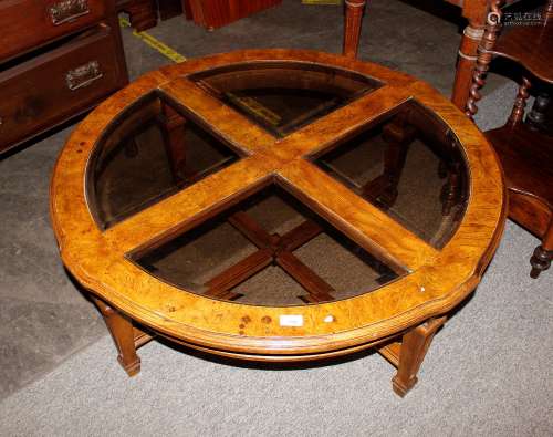 A 20th Century walnut and plate glass coffee table, with seg...