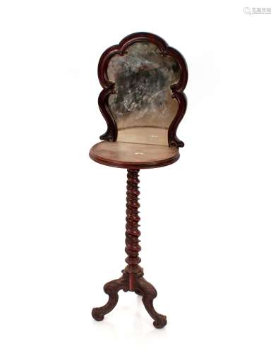 A Victorian walnut shaving stand, surmounted by a shaped mir...