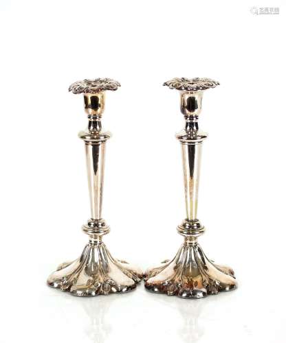 A pair of plated candlesticks, with detachable sconces raise...