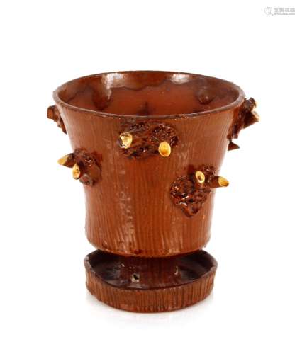 An unusual Staffordshire slipware vase, with raised tree stu...