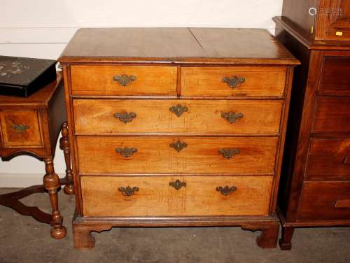 An 18th Century walnut chest, of two short and three long dr...